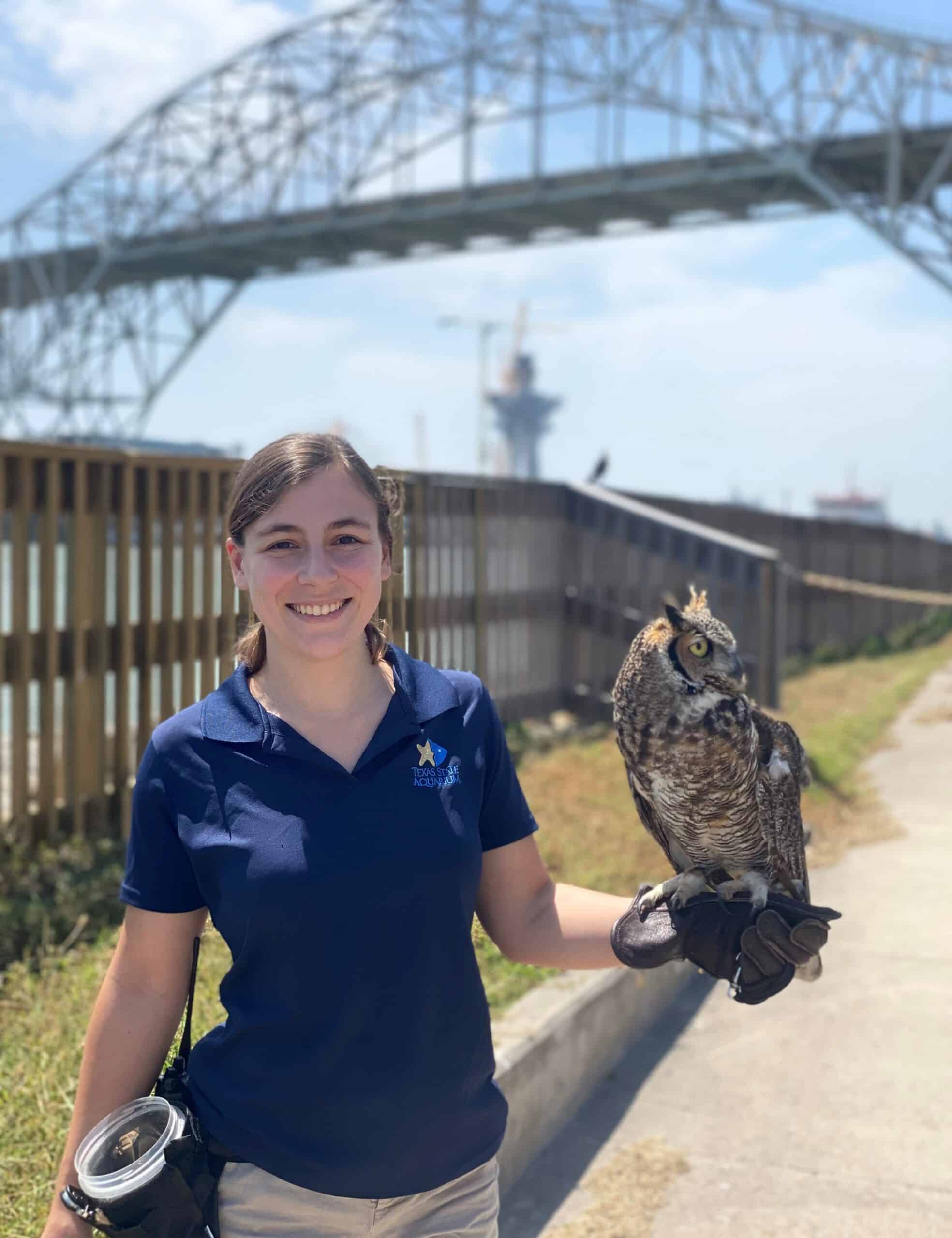 Texas State Aquarium employee holding an owl.