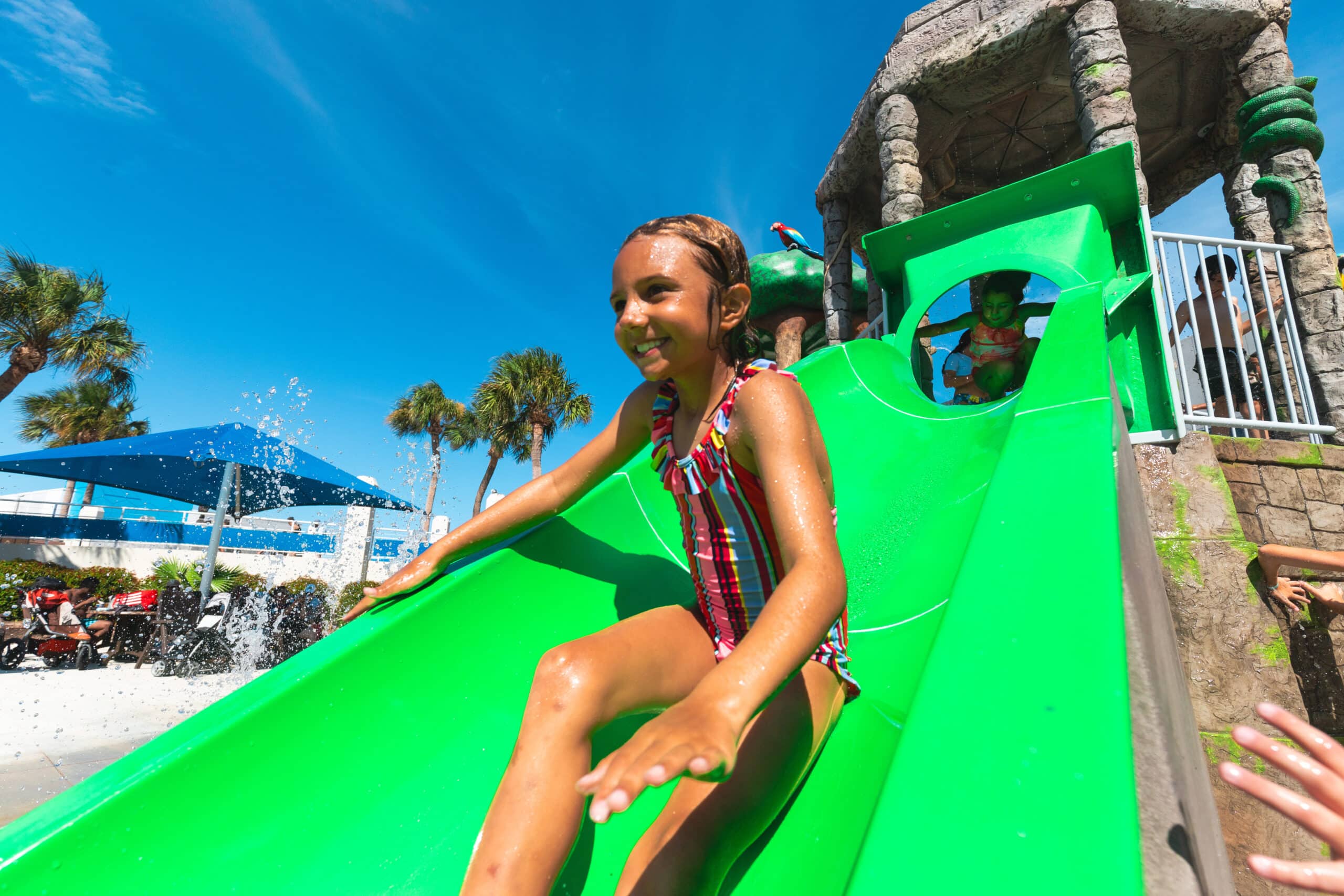 Girl going down splash park slide