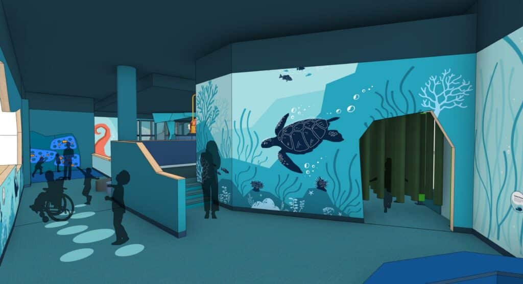 A colorful, underwater-themed indoor play area features ocean murals with sea turtles, fish, and coral. Silhouetted children play near stairs, a slide, and an entrance with curtains under blue lighting.